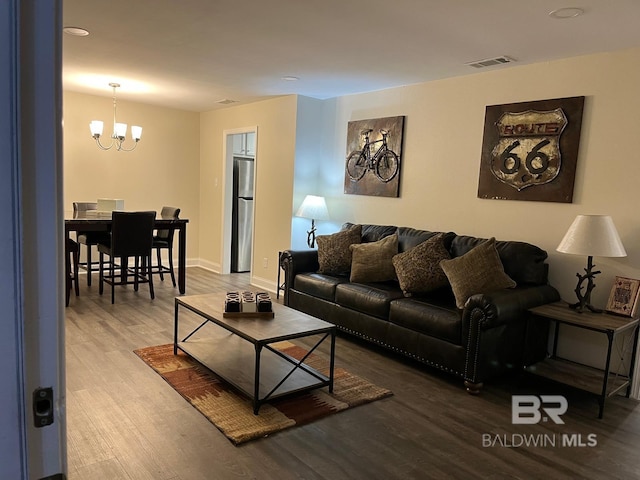 living room featuring hardwood / wood-style flooring and a notable chandelier