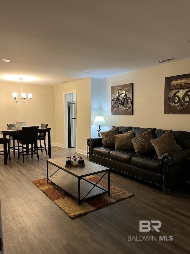 living room featuring hardwood / wood-style floors and a notable chandelier