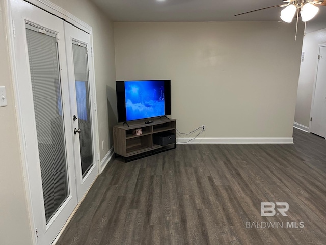 unfurnished living room with dark wood-type flooring, ceiling fan, and french doors