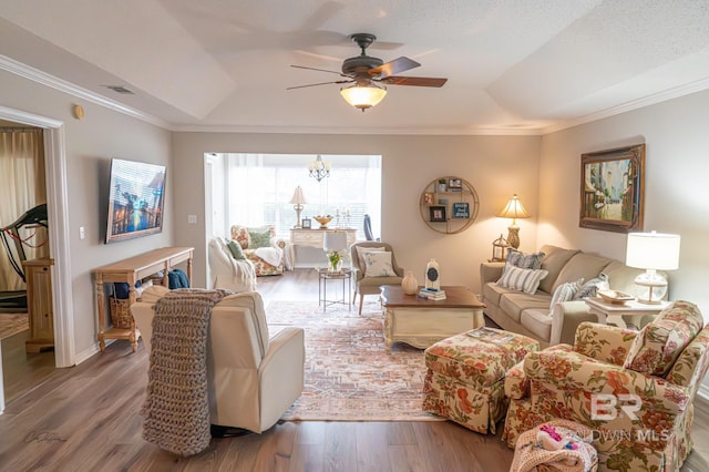 9362 Villas Dr, Foley, AL 36535 - living room with ceiling fan with notable chandelier, a raised ceiling, wood finished floors, and visible vents