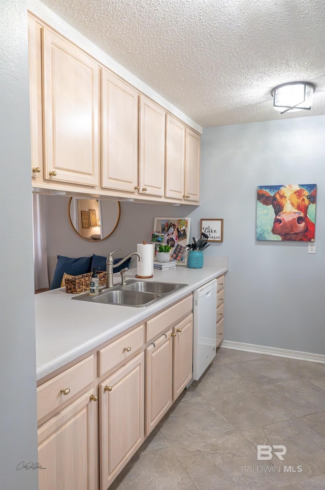 9362 Villas Dr, Foley, AL 36535 - kitchen featuring light countertops, baseboards, a textured ceiling, a sink, and white dishwasher