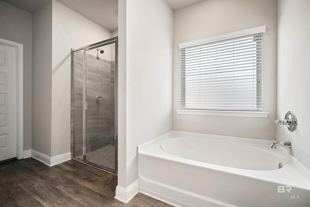 bathroom featuring hardwood / wood-style floors and independent shower and bath