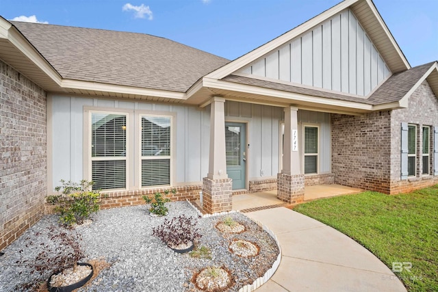 view of exterior entry with a lawn