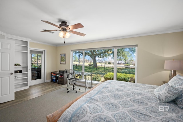 bedroom featuring access to exterior, multiple windows, crown molding, and wood finished floors