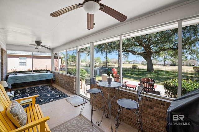 sunroom / solarium featuring ceiling fan