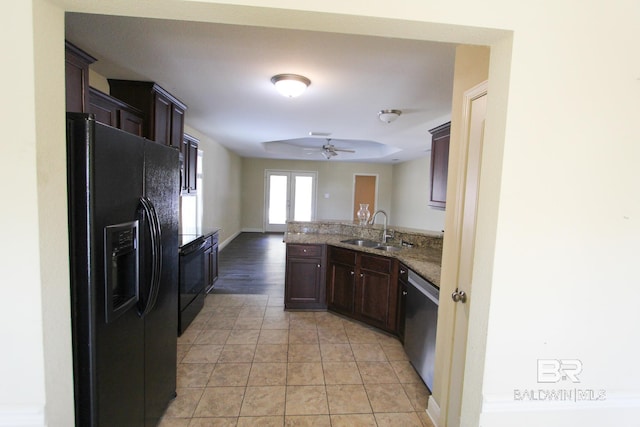 kitchen with black appliances, sink, light tile patterned floors, ceiling fan, and dark brown cabinetry