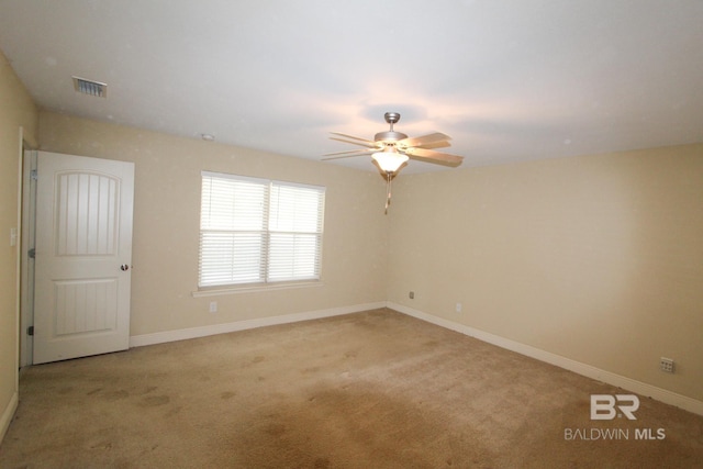 carpeted empty room featuring ceiling fan