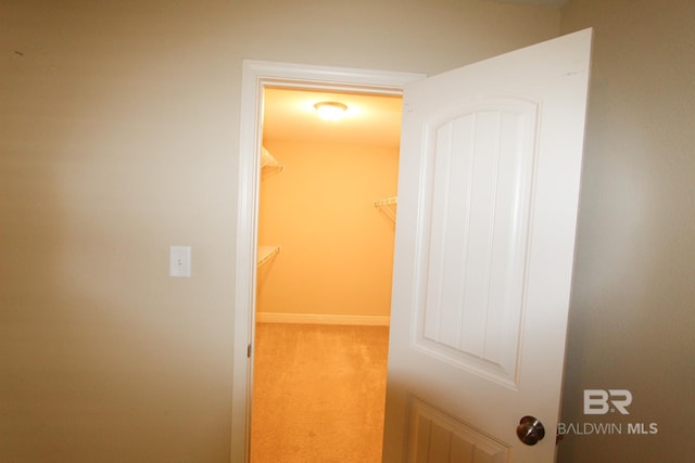 hall with light colored carpet