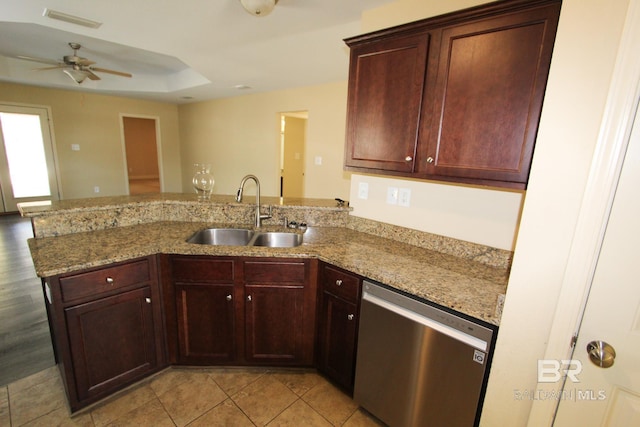 kitchen with sink, dishwasher, ceiling fan, light stone countertops, and kitchen peninsula