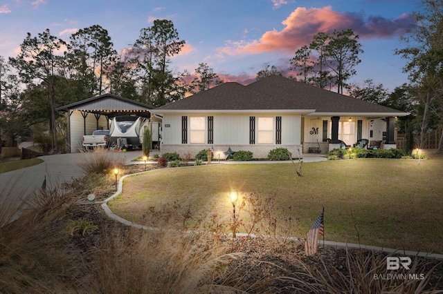 view of front of house with a lawn, a carport, and covered porch