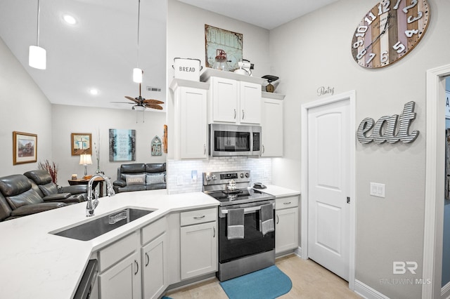 kitchen featuring decorative light fixtures, white cabinetry, sink, ceiling fan, and stainless steel appliances