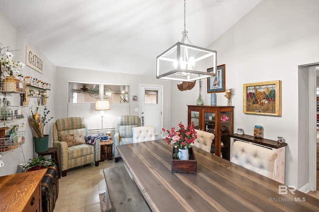 dining area featuring lofted ceiling and a notable chandelier