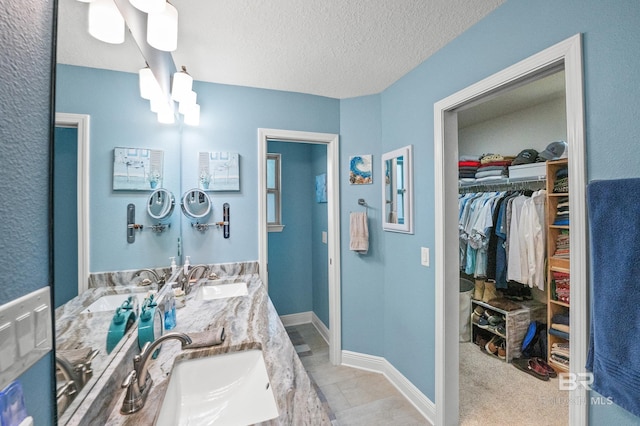 bathroom with vanity and a textured ceiling