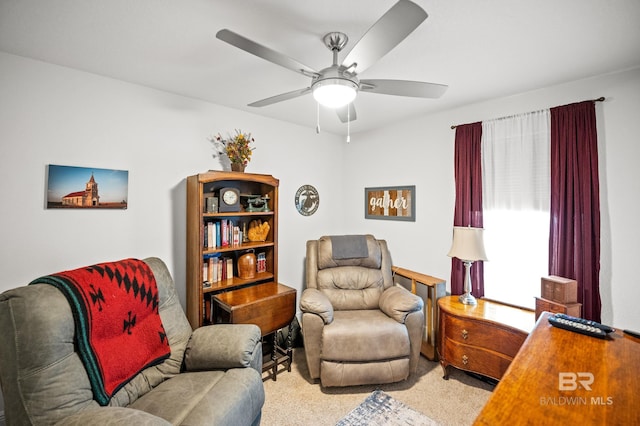 living area with ceiling fan and light carpet