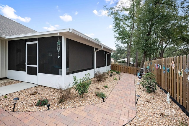 view of side of property with a sunroom