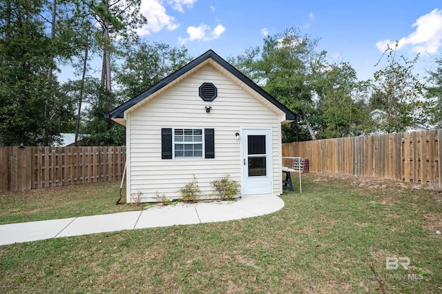 view of outdoor structure featuring a lawn