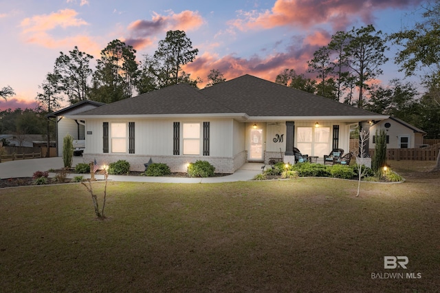 view of front of house with a yard and covered porch