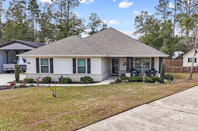 view of front of house with a front lawn and a carport