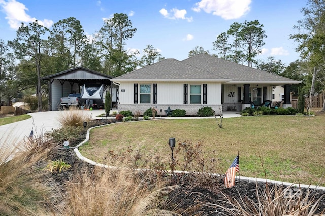 ranch-style home featuring a carport, covered porch, and a front yard