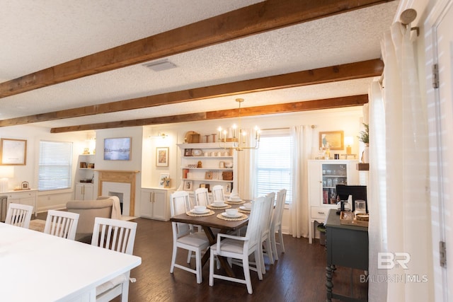 dining space featuring dark hardwood / wood-style flooring, beamed ceiling, a textured ceiling, and an inviting chandelier