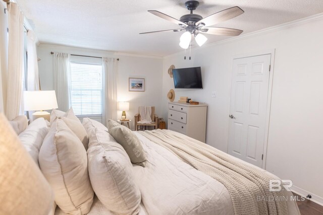 bedroom with crown molding, ceiling fan, hardwood / wood-style floors, and a textured ceiling