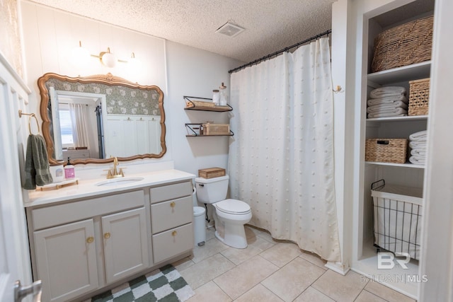 bathroom with tile patterned flooring, vanity, toilet, a textured ceiling, and a shower with curtain