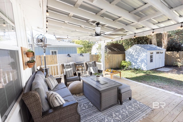 view of patio / terrace featuring a storage shed, an outdoor hangout area, ceiling fan, and a wooden deck