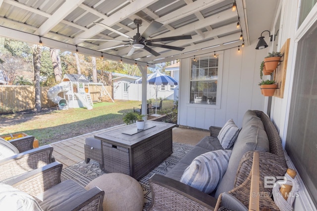 exterior space featuring a lawn, ceiling fan, a shed, outdoor lounge area, and a playground