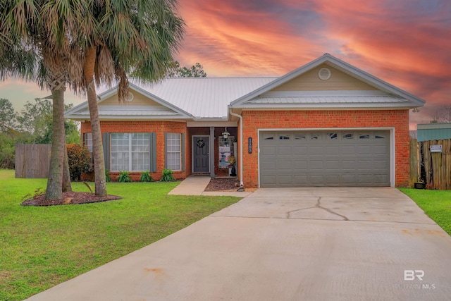 single story home featuring brick siding, a garage, concrete driveway, and a front lawn