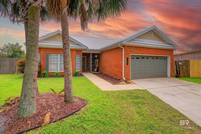 ranch-style house with driveway, a front lawn, fence, an attached garage, and brick siding