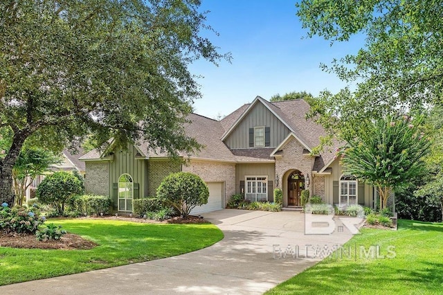 view of front of property featuring a garage and a front yard