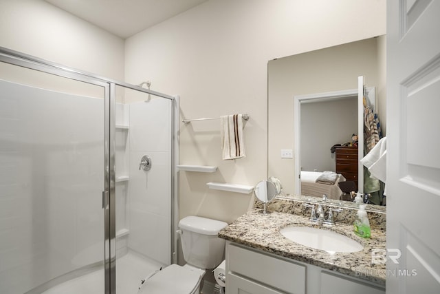 bathroom featuring walk in shower, vanity, and toilet