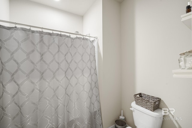 bathroom with a shower with curtain and toilet