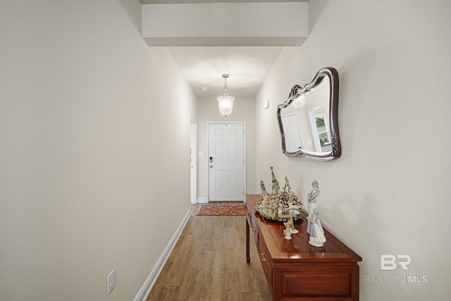 hallway with hardwood / wood-style floors