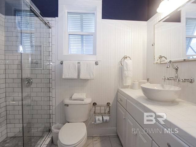 full bath featuring vanity, toilet, marble finish floor, and a shower stall