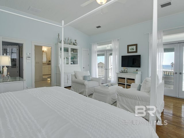 bedroom with access to exterior, visible vents, french doors, and wood finished floors