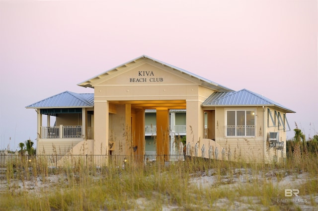 view of front facade featuring fence and metal roof