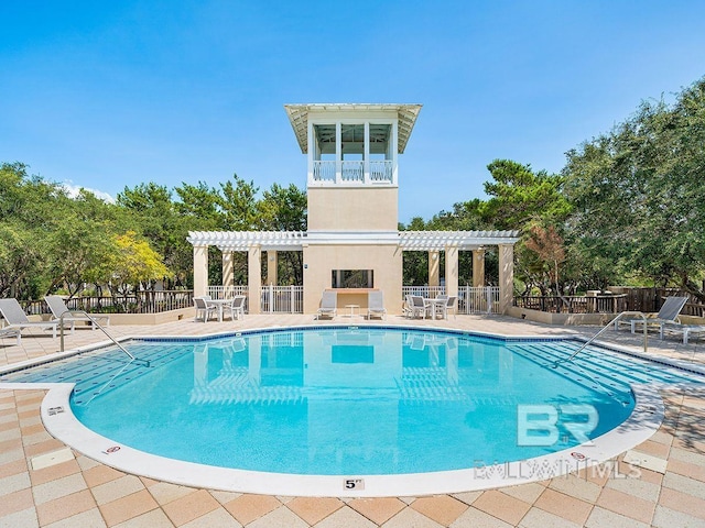 pool featuring a patio area, a pergola, and fence