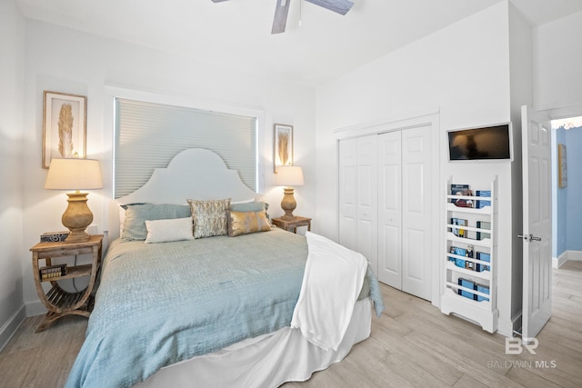 bedroom with a ceiling fan, baseboards, a closet, and light wood finished floors