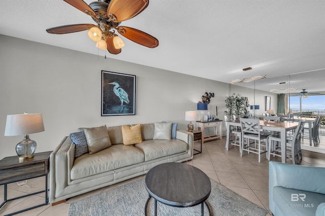 tiled living room with ceiling fan