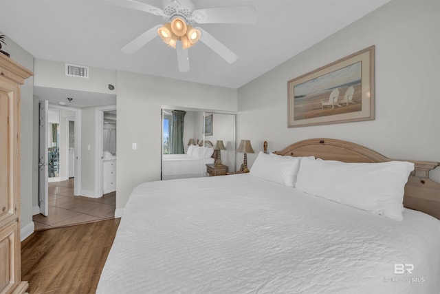 bedroom with a closet, hardwood / wood-style floors, and ceiling fan