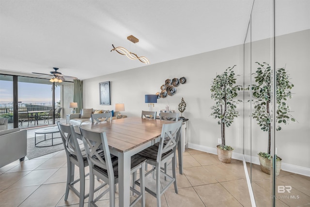 dining space with light tile patterned floors and ceiling fan