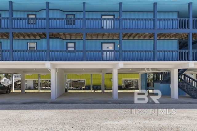 view of building exterior with a carport and stairs