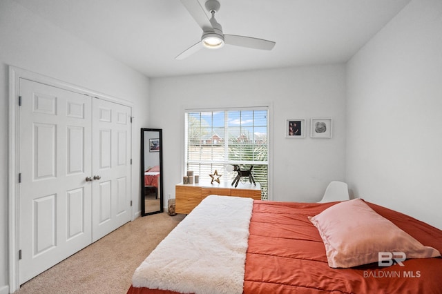 carpeted bedroom with ceiling fan and a closet