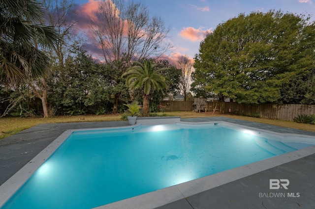 view of pool at dusk