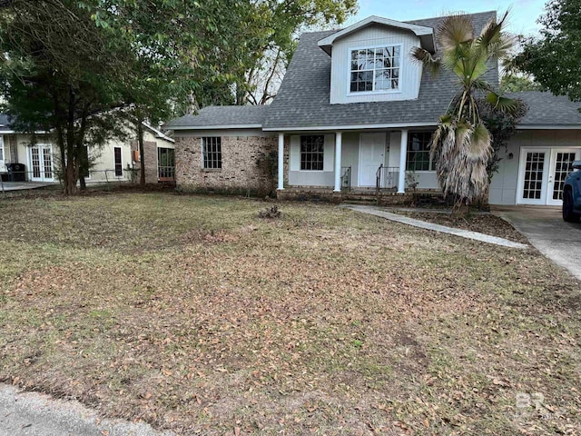 view of front of house featuring a front yard and french doors