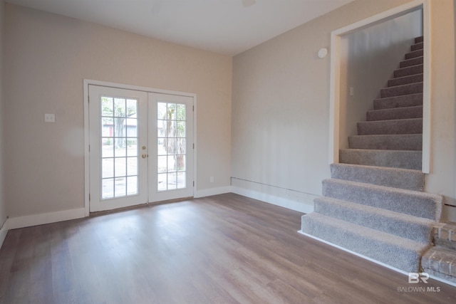 spare room featuring dark hardwood / wood-style floors and french doors