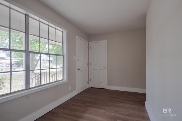 spare room with dark hardwood / wood-style flooring