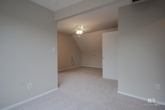 interior space featuring light colored carpet and vaulted ceiling