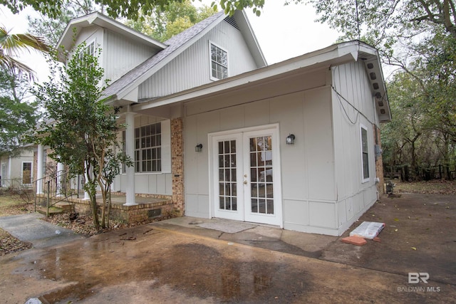 view of front of home featuring covered porch and french doors